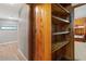 Wooden closet shelving in hallway at 5191 Cyril Dr, Dade City, FL 33523