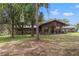 Stone and wood house exterior with birdhouse and yard at 5191 Cyril Dr, Dade City, FL 33523