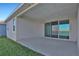 Covered patio with sliding glass doors and lake view at 7466 Sea Manatee St, Parrish, FL 34219