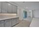 Modern kitchen with gray cabinets and access to patio at 7466 Sea Manatee St, Parrish, FL 34219