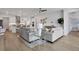 Open living room with kitchen view and wood floors at 7458 Sea Manatee St, Parrish, FL 34219