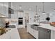 Modern kitchen with white cabinets, stainless steel appliances, and farmhouse sink at 7458 Sea Manatee St, Parrish, FL 34219