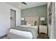 Bedroom with green accent wall and walk-in closet at 7458 Sea Manatee St, Parrish, FL 34219