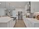 Modern kitchen with white cabinets, stainless steel appliances, and quartz countertops at 7458 Sea Manatee St, Parrish, FL 34219