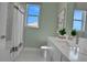 Modern bathroom with white cabinets, quartz countertops, and a shower/tub combo at 7458 Sea Manatee St, Parrish, FL 34219