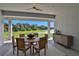 Relaxing patio with wooden furniture and a view of a serene lake at 7458 Sea Manatee St, Parrish, FL 34219