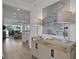 Bright and airy entryway with light wood cabinet and large artwork at 7458 Sea Manatee St, Parrish, FL 34219
