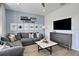 Game room with sectional sofa, large TV, and game decor at 7458 Sea Manatee St, Parrish, FL 34219