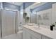 Bathroom with white vanity, shower, and gray walls at 7458 Sea Manatee St, Parrish, FL 34219