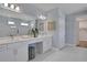 Elegant bathroom with double vanity, large mirror, and walk-in shower at 7458 Sea Manatee St, Parrish, FL 34219