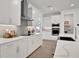 Modern kitchen featuring white cabinets, gray herringbone backsplash, and stainless steel appliances at 7458 Sea Manatee St, Parrish, FL 34219