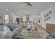 Open concept living room with kitchen views and access to outdoor patio at 7458 Sea Manatee St, Parrish, FL 34219