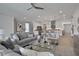 Open concept living area with gray sectional sofa and views into kitchen at 7458 Sea Manatee St, Parrish, FL 34219