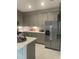 Modern kitchen with gray cabinets, stainless steel appliances, and quartz countertops at 9230 Gulf Haven Dr, Parrish, FL 34219