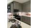 Modern kitchen with stainless steel appliances and light gray cabinets at 9246 Gulf Haven Dr, Parrish, FL 34219