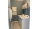 Neat laundry room with washer, dryer, and storage shelves at 9246 Gulf Haven Dr, Parrish, FL 34219