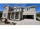 Two-story house with a neutral color scheme and a three car garage at 7446 Sea Manatee St, Parrish, FL 34219