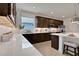 Modern kitchen with dark wood cabinets and a large island at 7438 Sea Manatee St, Parrish, FL 34219