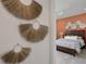 Bedroom with a large bed, an accent wall, and a dresser at 7438 Sea Manatee St, Parrish, FL 34219