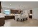 Modern kitchen with dark cabinetry and large island at 7438 Sea Manatee St, Parrish, FL 34219