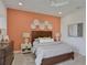 Bright bedroom with a wooden bed frame and accent wall at 7438 Sea Manatee St, Parrish, FL 34219