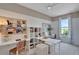 Home office with two desks, built-in shelving, and corkboards at 7438 Sea Manatee St, Parrish, FL 34219