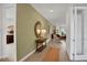 Bright hallway with wood-look floors, leading to living areas and bedrooms at 7438 Sea Manatee St, Parrish, FL 34219