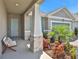 Covered porch entry with stone pillars and a relaxing bench at 7434 Sea Manatee St, Parrish, FL 34219