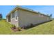Side view of house showing exterior finishes and landscaping at 7434 Sea Manatee St, Parrish, FL 34219