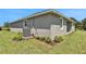 Side view of the house showcasing landscaping and AC unit at 7434 Sea Manatee St, Parrish, FL 34219