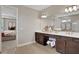 Elegant bathroom with double vanity and view of bedroom at 7434 Sea Manatee St, Parrish, FL 34219