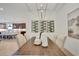 Modern dining area with a wooden table, wine rack, and decorative vases at 7434 Sea Manatee St, Parrish, FL 34219