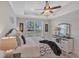 Bright main bedroom with ceiling fan and large window, dresser at 9234 Gulf Haven Dr, Parrish, FL 34219