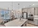 Modern kitchen with stainless steel appliances and an island breakfast bar at 9234 Gulf Haven Dr, Parrish, FL 34219