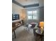 Living room with gray sectional sofa, a coffee table, and a media console at 7582 Sea Oak Ct, Parrish, FL 34219