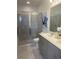 Modern bathroom with double vanity, shower, and updated fixtures at 7582 Sea Oak Ct, Parrish, FL 34219