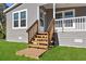 Wooden steps leading to the front door of the gray house at 12351 Lamont Ave, New Port Richey, FL 34654