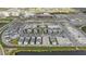 Aerial view of new construction community with a pond and empty lots for future construction at 176 Eagleston Ln, Lakewood Ranch, FL 34240
