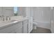 Bright bathroom features a double sink vanity, white cabinets, and a shower-tub combo at 176 Eagleston Ln, Lakewood Ranch, FL 34240