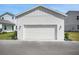 A bright white garage with ample space and traditional carriage doors complements the modern home design at 176 Eagleston Ln, Lakewood Ranch, FL 34240