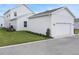 A bright white garage with ample space and traditional carriage doors complements the modern home design at 176 Eagleston Ln, Lakewood Ranch, FL 34240