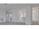 Bright hallway featuring neutral carpet, white walls, and doors to various rooms, including a bathroom at 176 Eagleston Ln, Lakewood Ranch, FL 34240