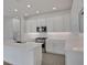 Bright kitchen with stainless steel appliances, white cabinets, subway tile backsplash and kitchen island at 176 Eagleston Ln, Lakewood Ranch, FL 34240