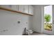 Clean laundry room with a storage shelf and a view to the backyard at 176 Eagleston Ln, Lakewood Ranch, FL 34240