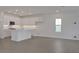 Open-concept living space showcasing a kitchen with an island and tile flooring at 176 Eagleston Ln, Lakewood Ranch, FL 34240