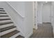 Well-lit staircase featuring modern stair treads with a light colored finish and white risers at 176 Eagleston Ln, Lakewood Ranch, FL 34240
