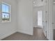 Bright bedroom featuring wood-look tile flooring and a window with a neighborhood view at 180 Eagleston Ln, Lakewood Ranch, FL 34240