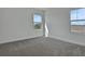 Neutral bedroom with carpet and two windows offering a neighborhood view at 180 Eagleston Ln, Lakewood Ranch, FL 34240