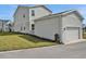 Side view of a home with an attached garage and well-maintained lawn at 180 Eagleston Ln, Lakewood Ranch, FL 34240