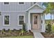 Inviting entryway with a charming pink front door and manicured landscaping at 180 Eagleston Ln, Lakewood Ranch, FL 34240